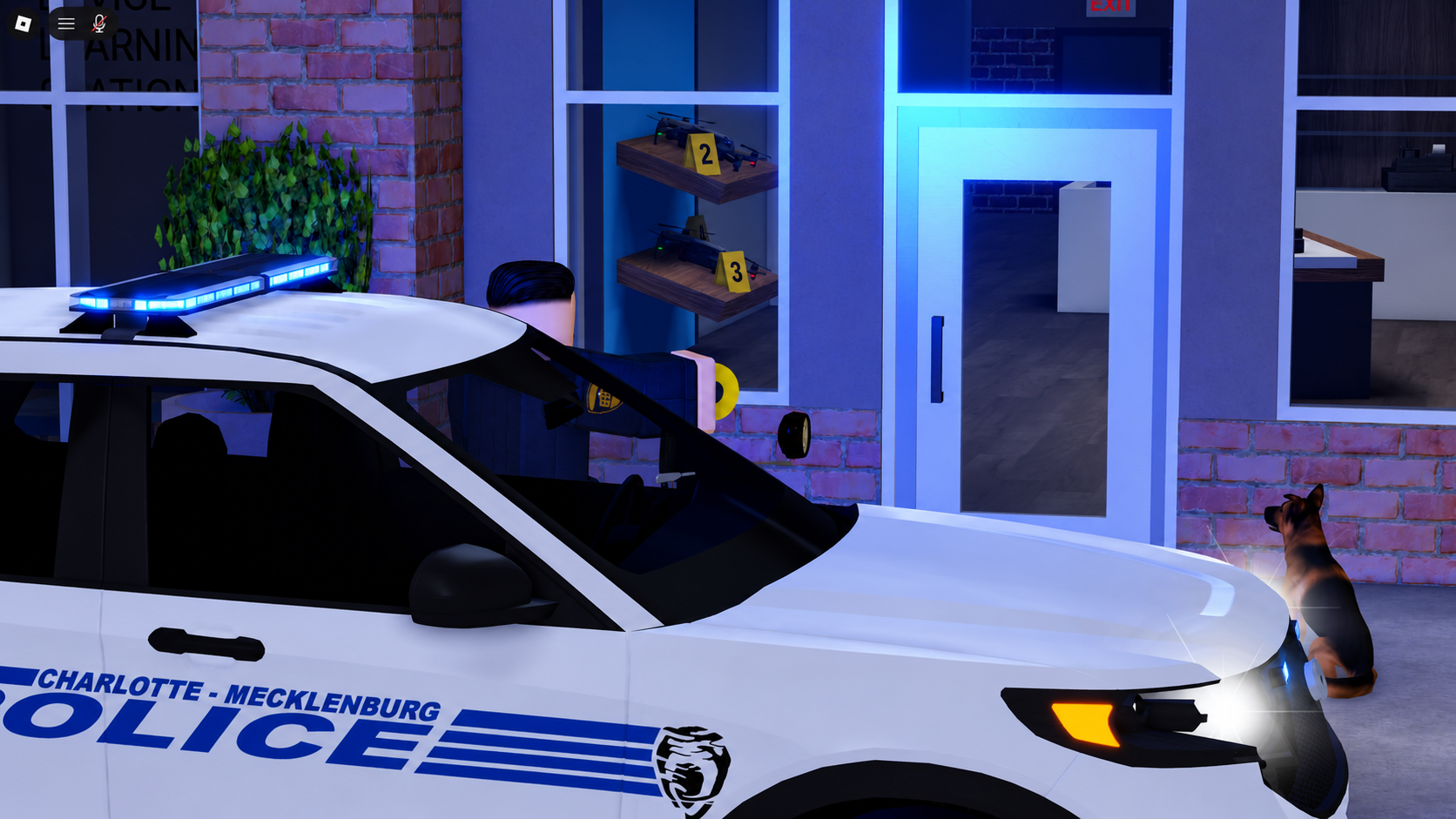 A Charlotte-Mecklenburg Police cruiser with its lightbar on, parked outside a brick storefront with a K9 unit beside it